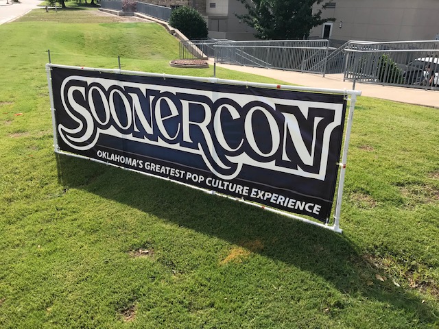An outdoor sign promoting the SoonerCon convention
